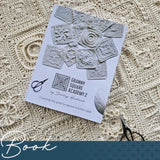Granny Square Academy 2 book is laying on a blac=nket made from Granny Squares