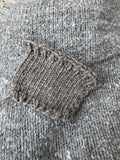 Close-up of textured gray fabric with a knitted pattern