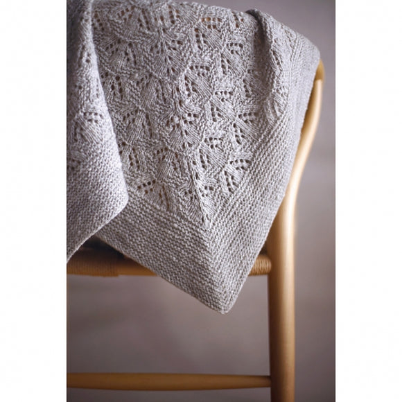 the photo shows the azami shawl draped over a chair. The photo was taken by the designer Noriko Ichikawa